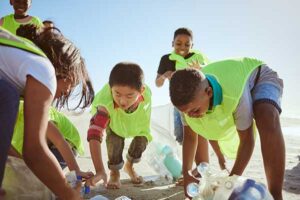 kids gathering recycling on the beach