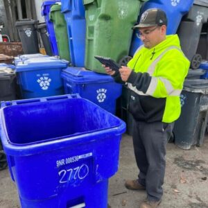 officer looking at trash can
