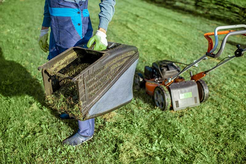 grass-cycling person mowing lawn